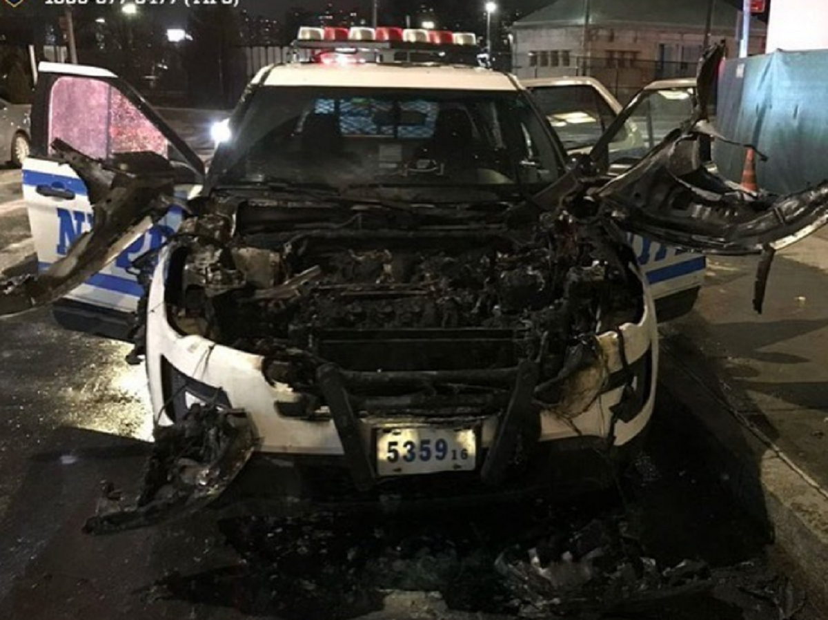 COP CAR GETS BURNT TO A CRISP BY SUSPECTS