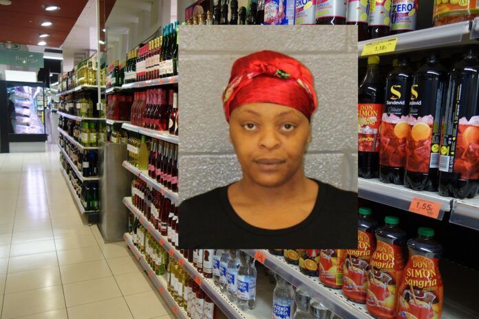 WOMAN WITH HAIR BONNET ON ARRESTED CHARGED WITH STEALING TEQUILA FROM ABC STORE ON NORTH TRYON